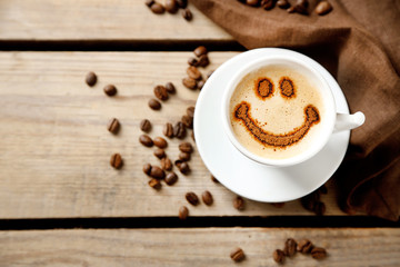 Obraz premium Cup of coffee on old wooden table