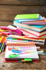 Bright school stationery on old wooden table