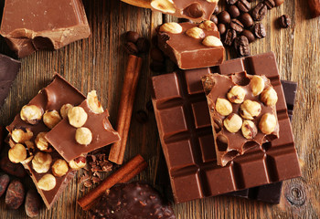 Still life with set of chocolate on wooden table, top view