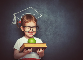 girl schoolgirl with books and apple in a school board