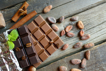 Delicious chocolate with spices on wooden table, closeup