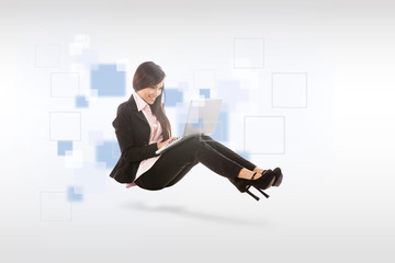 Asian smiling businesswoman with notebook is sitting on the floo