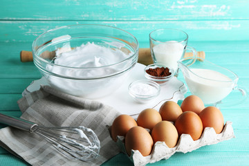 Whipped egg whites for cream on color wooden background