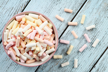 Sweet candies on wooden table, top view