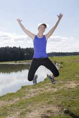 young woman jumping outdoors