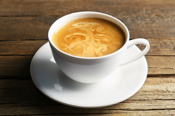 Cup of coffee latte art on wooden background