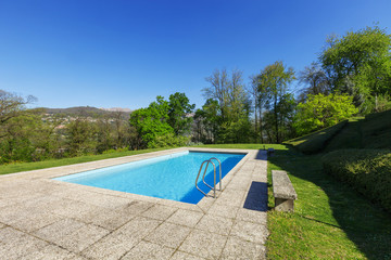 Outside of modern house in summer, swimming pool
