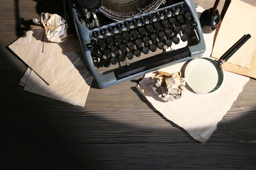 Retro typewriter on wooden background