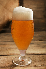 Glass of beer on wooden background