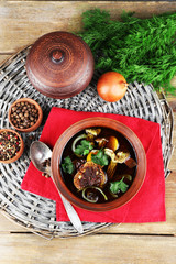 Mushroom soup on wicker mat and color napkin, top view