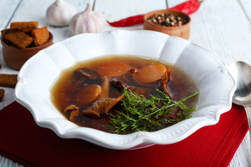 Mushroom soup on wooden table, closeup