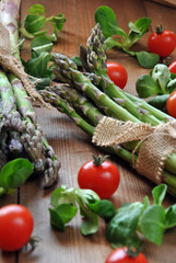 organic asparagus on wooden table accompanied
