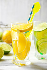 Cocktails with fresh citrus fruits on wooden background