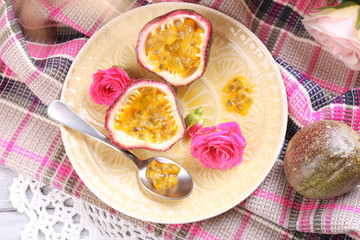 Passion fruit on plate on color napkin background