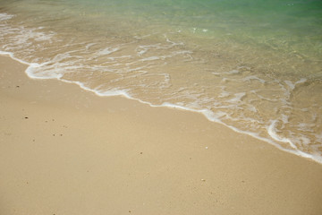 Fototapeta na wymiar Wave of the sea on sandy beach.