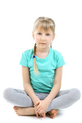 Little girl doing exercises isolated on white