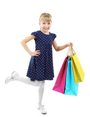 Beautiful little girl with shopping bags isolated on white