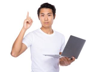 Young man hold with laptop and pointing out an idea