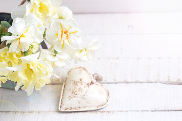 Background with fresh narcissus and heart