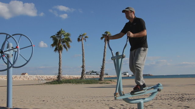 Man on the beach practicing on stepper