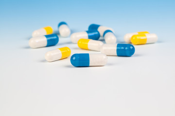 Colorful medical capsules on white background.
