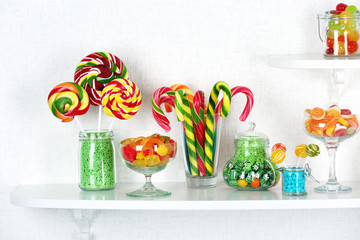 Fototapeta na wymiar Colorful candies in jars on shelves close-up