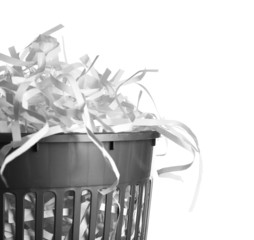 Strips of destroyed paper from shredder in trash can isolated