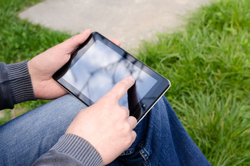 Man  using tablet pc in the park