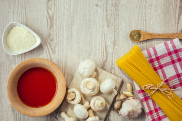 spaghetti and other ingredients, parmesan, oregano on table