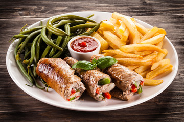 Wrapped pork chop, chips and vegetables