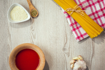 Fototapeta na wymiar spaghetti and other ingredients, parmesan, oregano on table
