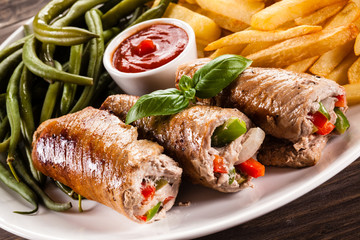 Wrapped pork chop, chips and vegetables
