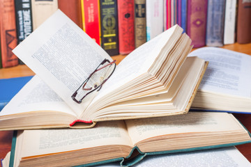 A lot of open books on the desk