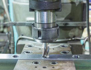 Tapping metal box by machine