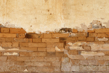 The old cracked wall of the abandoned ruins.