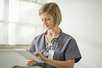Caucasian nurse holding digital tablet