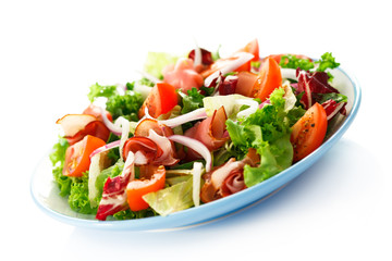 Smoked ham and vegetables on white background