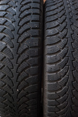 Car tires in a row on a shelf tire