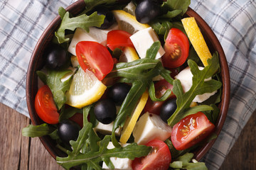 Salad with vegetables, feta and lemon horizontal top view