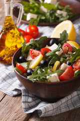 fresh salad with arugula, feta cheese and tomatoes, vertical