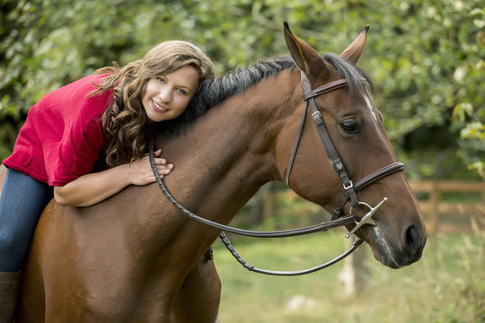 Caucasian woman sitting on horse outdoors