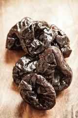 dried plums prunes on wooden table