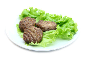 veal cutlet with lettuce on white background
