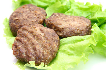 veal cutlet with lettuce on white background