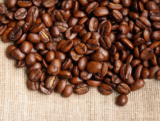 Background from coffee beans on fabric closeup