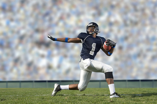 African American football player poised on field