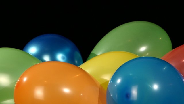 Lot of multicolored balloons, rotation, on black background