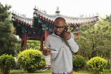 Black man reading map on city street, Beijing, Beijing, China