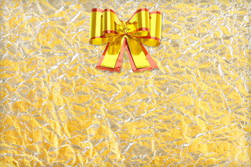 Shiny yellow leaf gold and  silver ribbon on Shiny foil texture