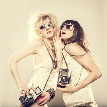 Caucasian women posing with cameras